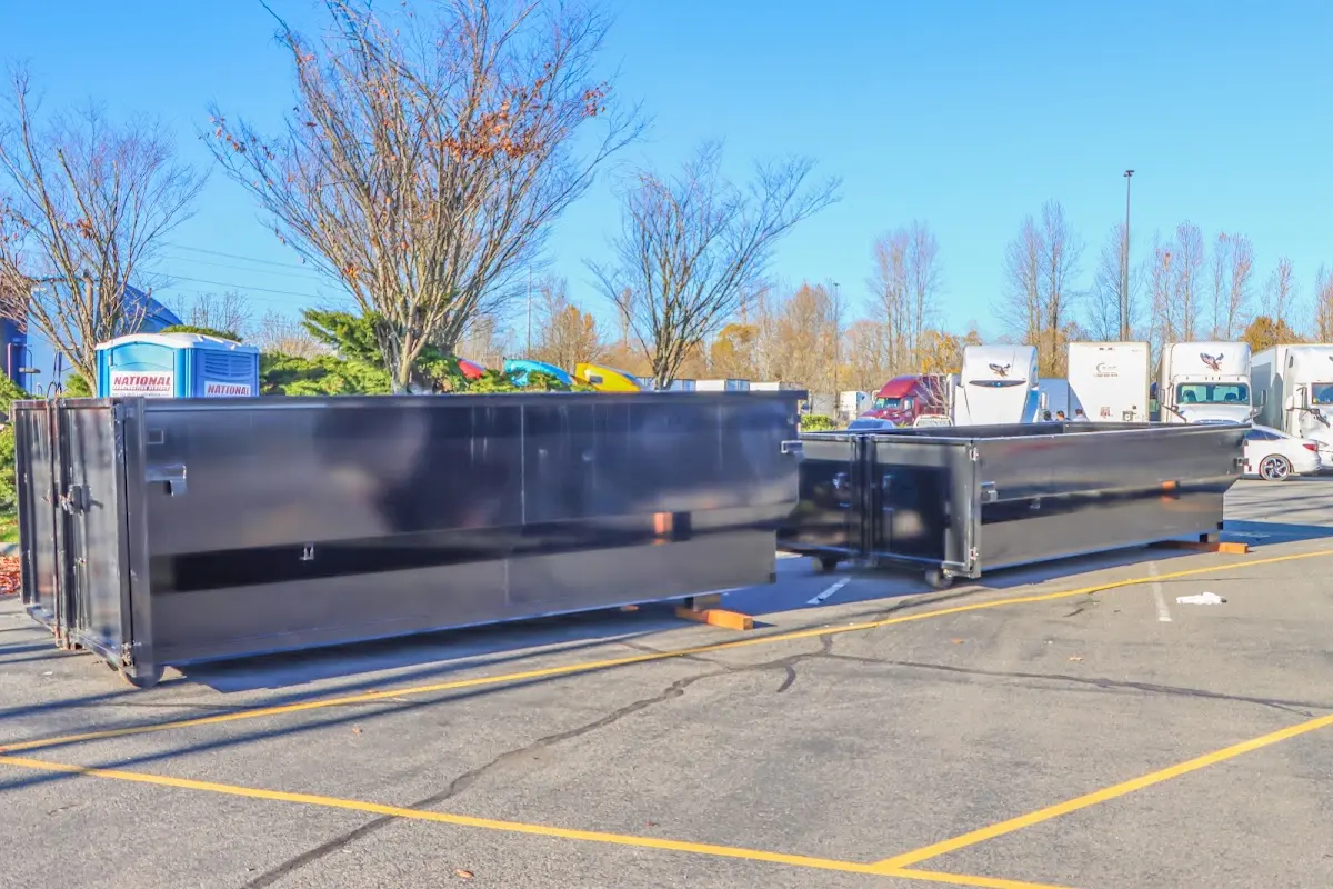 Professional dumpster rental service with roll-off container on residential driveway in Mendota Heights